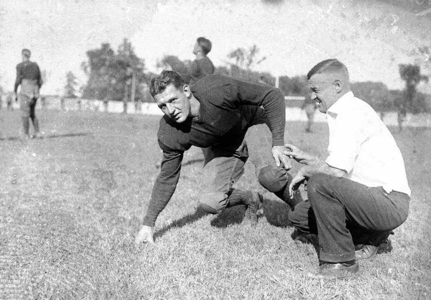 FILE--Red Grange, half-back for the University of Illinois, poses with coach Bob Zuppke, right, during football practice, in this 1925 file photo. Grange is a featured played in ESPN's "Rites of Autumn," a 10-part series about college football that debuts on the cable channel Friday, Oct. 12, 2001. (AP Photo) ORG XMIT: NY353